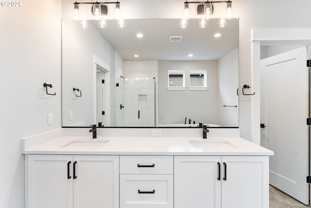 bathroom featuring an enclosed shower and vanity