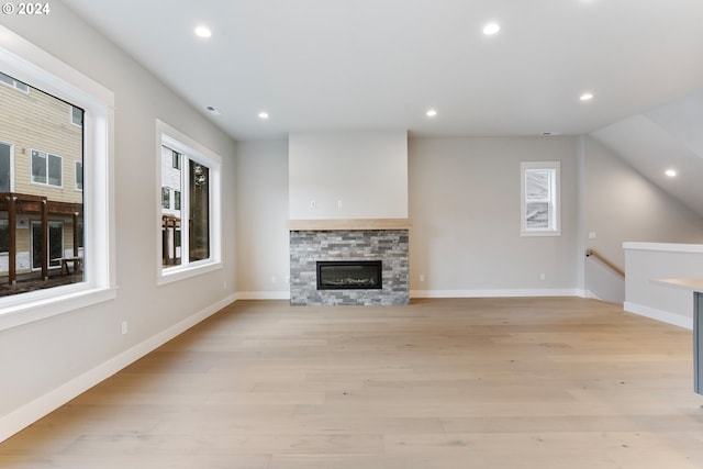 unfurnished living room featuring light hardwood / wood-style floors and a fireplace