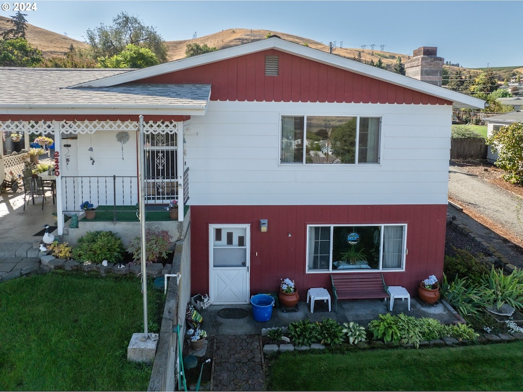 rear view of property with a lawn and a patio