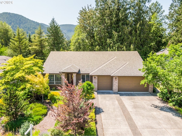 view of front of home featuring a mountain view and a garage