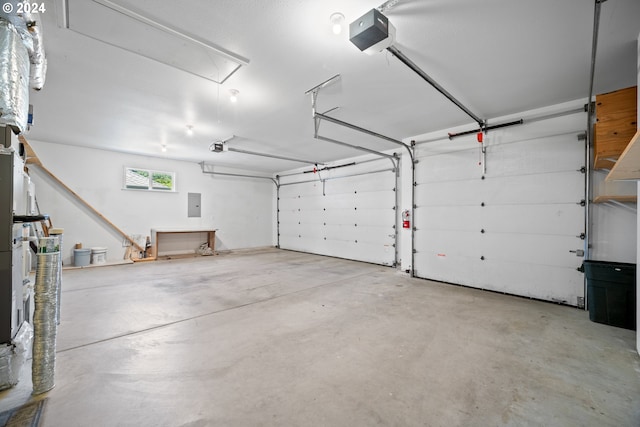 garage with a garage door opener and electric panel