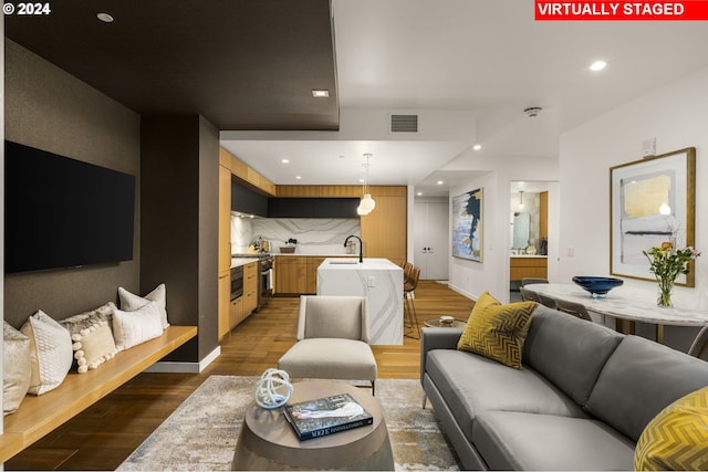 living room with dark wood-type flooring and sink