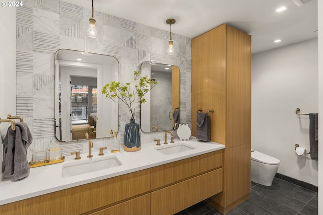 bathroom featuring toilet, large vanity, tasteful backsplash, dual sinks, and tile flooring