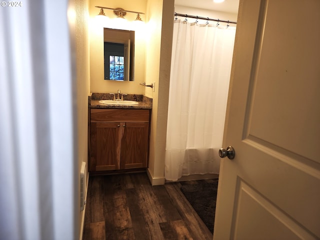 bathroom featuring vanity, shower / tub combo with curtain, and wood-type flooring