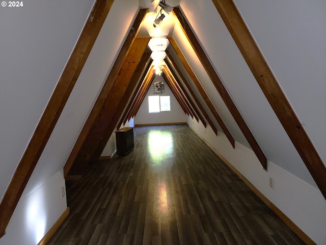 bonus room featuring dark wood-type flooring and lofted ceiling with beams