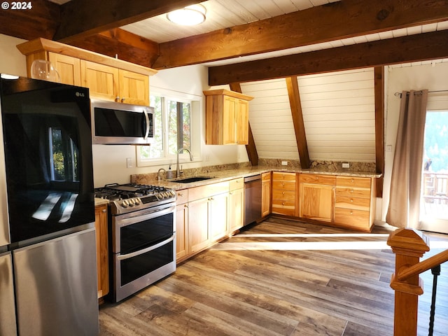 kitchen featuring beam ceiling, hardwood / wood-style flooring, stainless steel appliances, and sink