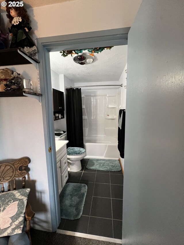 full bathroom with shower / tub combo, vanity, tile patterned flooring, and toilet