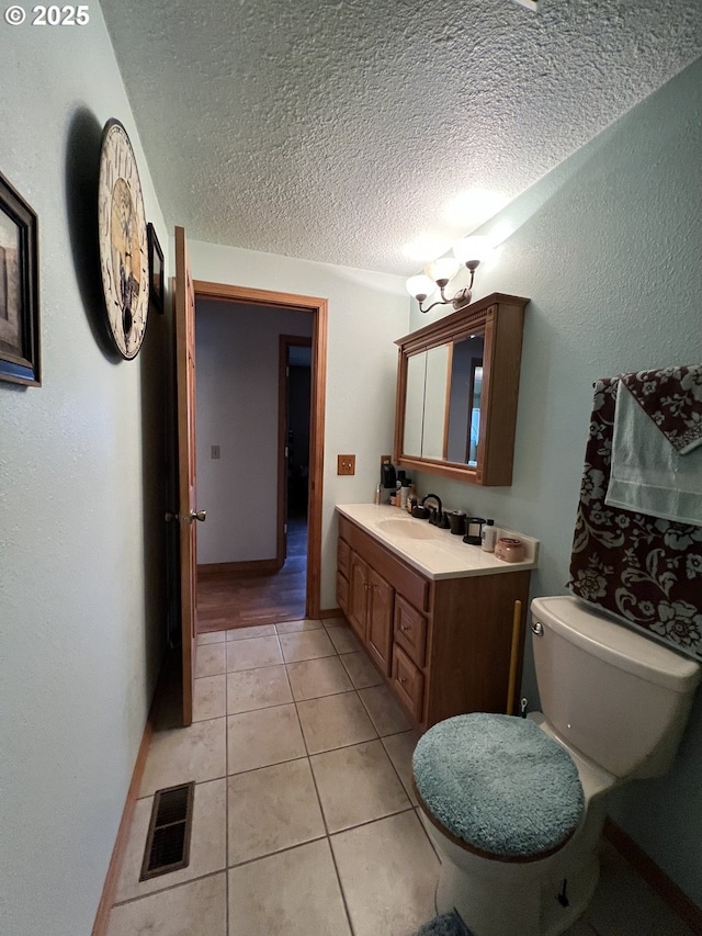 304 SE Hillcrest Dr, John Day, OR 97845 - half bathroom with tile patterned floors, a textured ceiling, toilet, and vanity