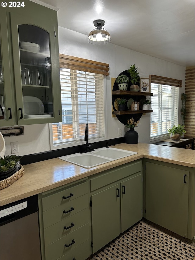 kitchen with green cabinetry, sink, and stainless steel dishwasher