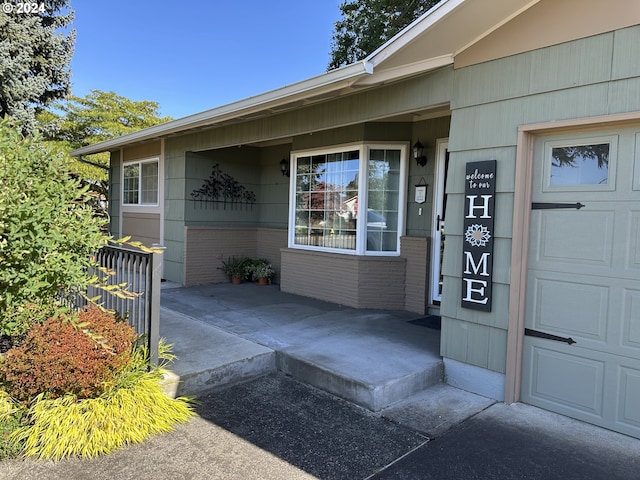 view of exterior entry with a garage