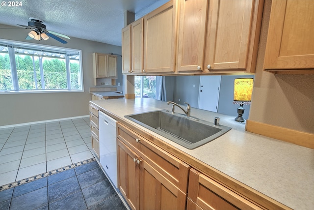 kitchen featuring ceiling fan, dishwasher, sink, tile patterned flooring, and a textured ceiling