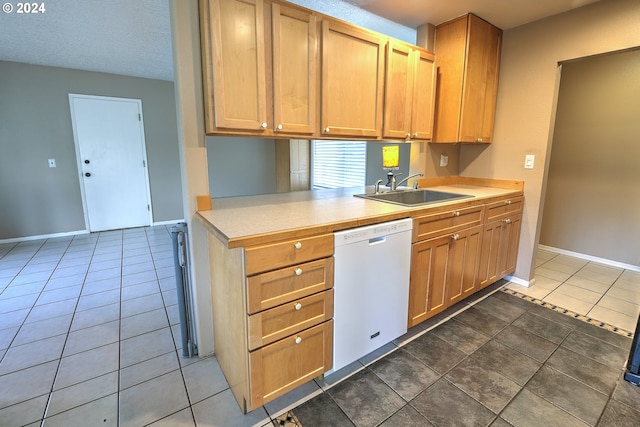 kitchen featuring white dishwasher, dark tile patterned floors, sink, and a textured ceiling