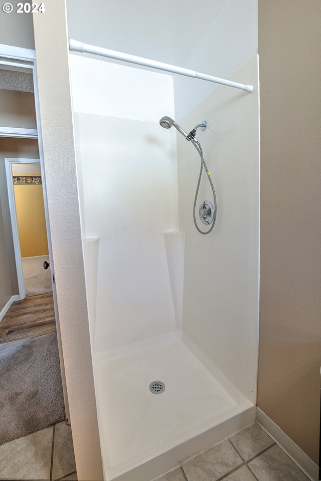 bathroom with tile patterned floors and walk in shower