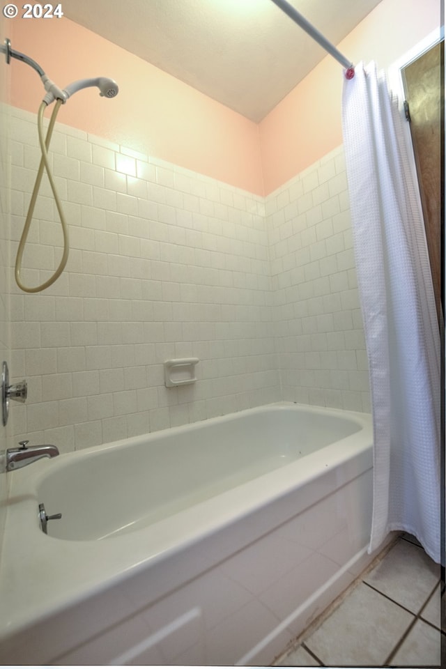 bathroom with shower / tub combo with curtain and tile patterned flooring