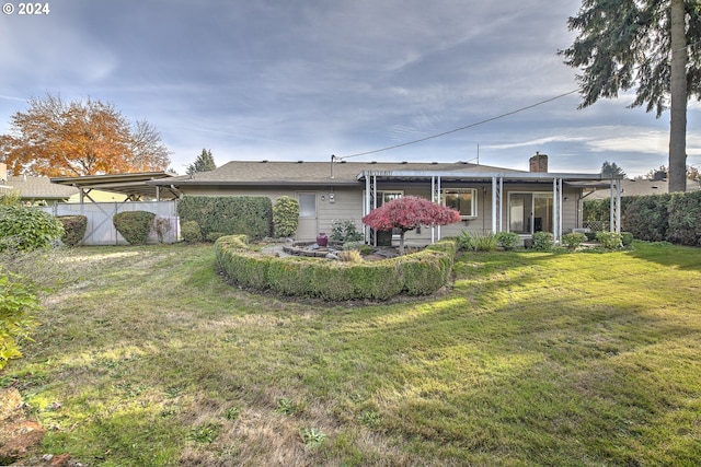 rear view of property with a lawn