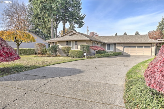 ranch-style home with a front yard and a garage