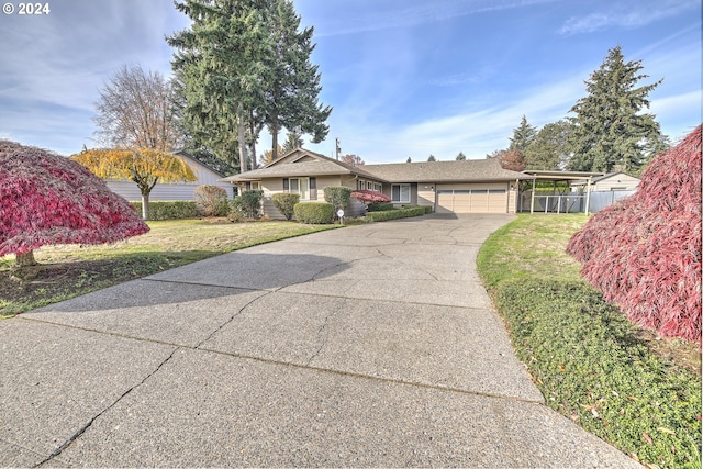 single story home with a carport, a garage, and a front yard