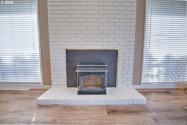 details featuring hardwood / wood-style flooring and a wood stove