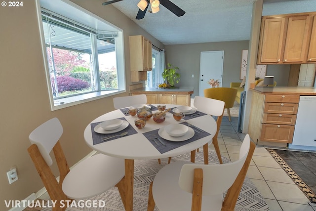 dining space featuring ceiling fan, light tile patterned floors, and a textured ceiling