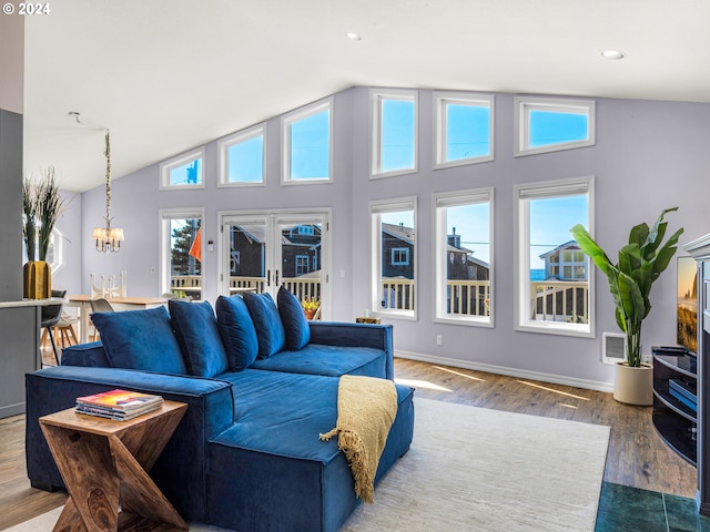 living room featuring french doors, a notable chandelier, dark hardwood / wood-style floors, and high vaulted ceiling