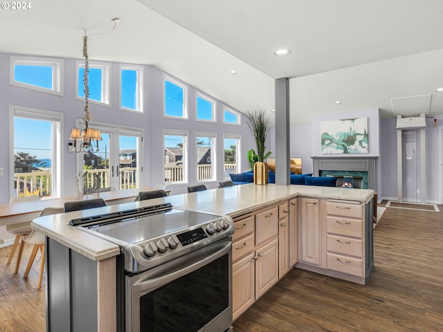 kitchen featuring high vaulted ceiling, light brown cabinets, dark hardwood / wood-style flooring, stainless steel range with electric cooktop, and a premium fireplace