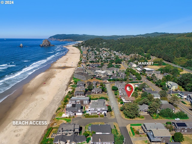 bird's eye view with a water view and a beach view