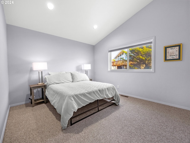 bedroom featuring carpet floors and lofted ceiling