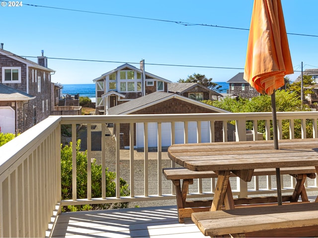 wooden terrace featuring a water view and a garage