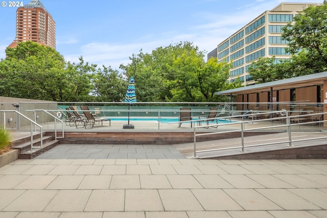 view of swimming pool featuring a patio area