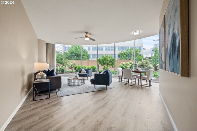 interior space with light hardwood / wood-style flooring, ceiling fan, and floor to ceiling windows