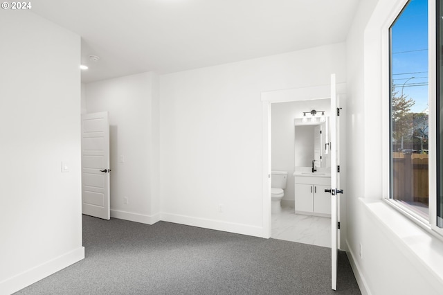 hallway featuring light colored carpet