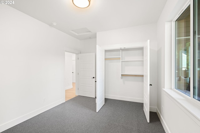 unfurnished bedroom with a closet and carpet flooring