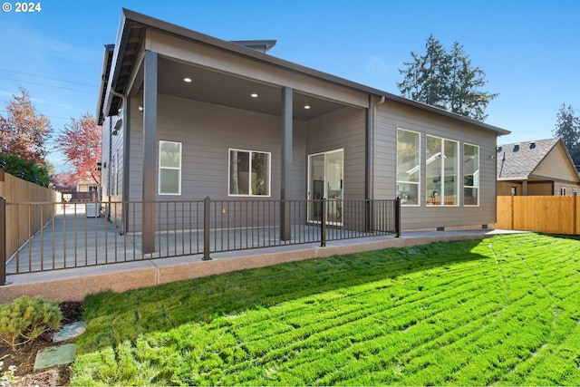 back of house featuring a yard and a patio area