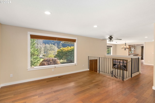 empty room with a chandelier and hardwood / wood-style floors