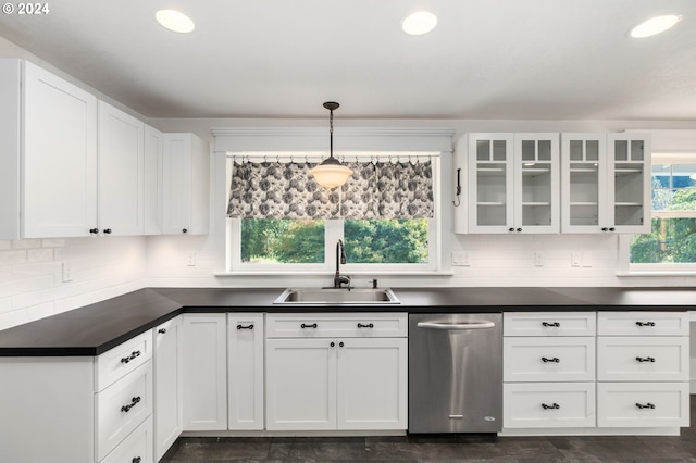 kitchen featuring white cabinetry, stainless steel dishwasher, sink, and hanging light fixtures