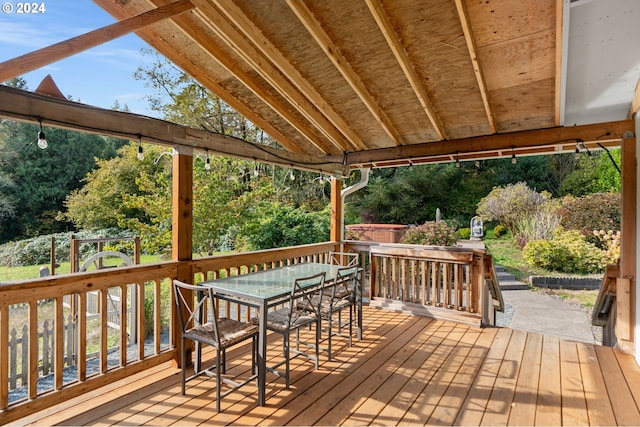 wooden deck with a hot tub