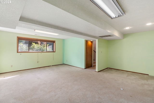 carpeted spare room featuring a textured ceiling