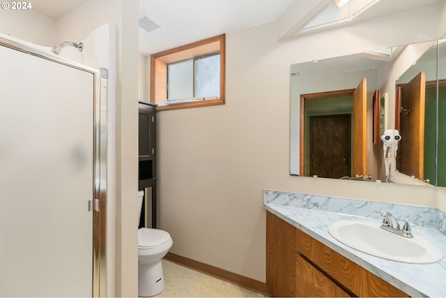 bathroom with walk in shower, vanity, and toilet