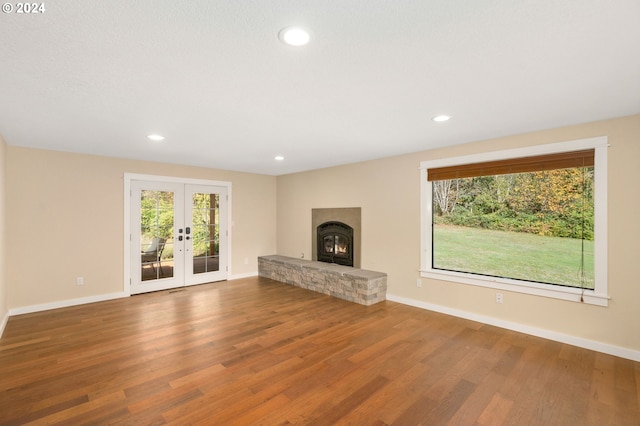 unfurnished living room featuring french doors and hardwood / wood-style flooring