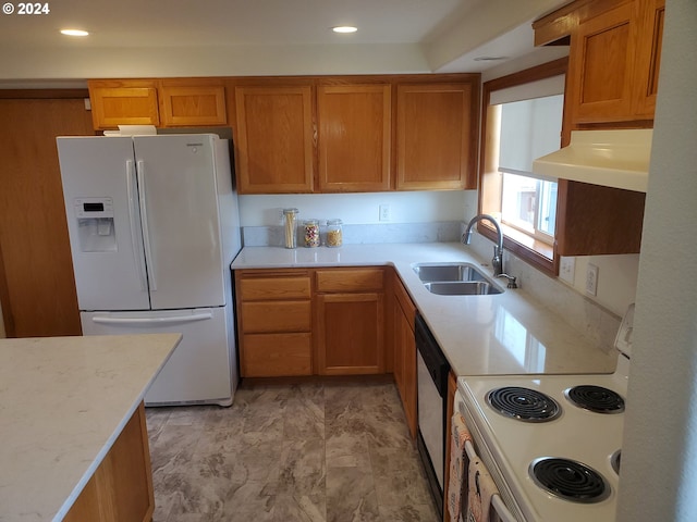 kitchen featuring white appliances, sink, and exhaust hood