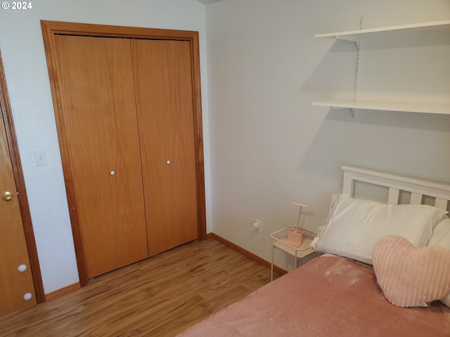 unfurnished bedroom featuring a closet and light hardwood / wood-style flooring