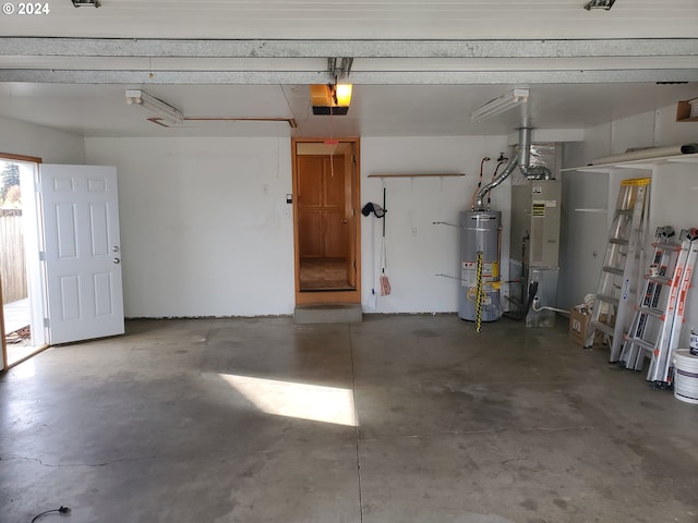 garage with a garage door opener, heating unit, and gas water heater