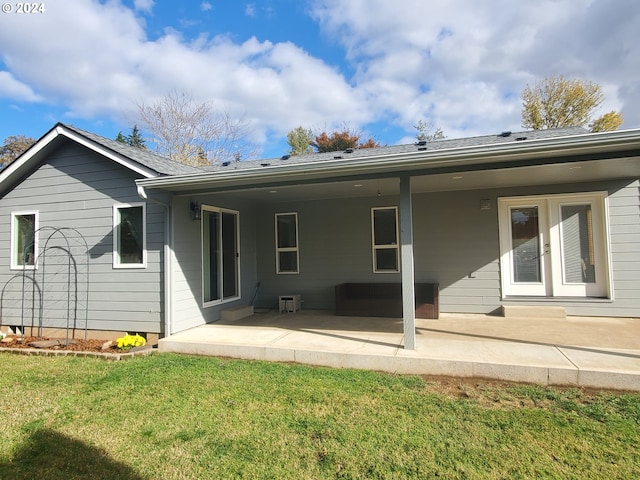 rear view of house featuring a yard and a patio area