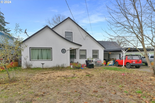 rear view of house featuring a garage