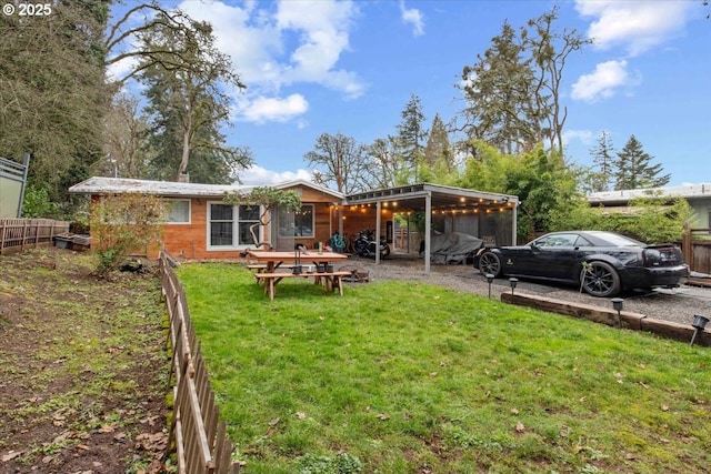 rear view of property with a lawn