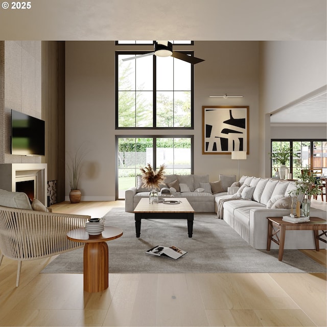 living room with a towering ceiling and light wood-type flooring