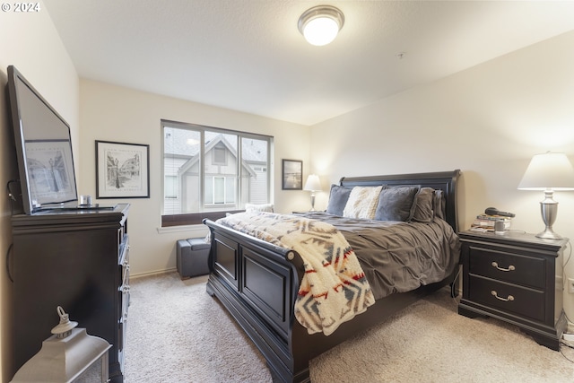 carpeted bedroom with vaulted ceiling