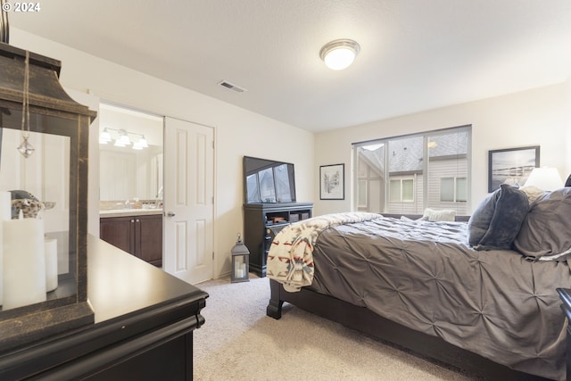 carpeted bedroom with ensuite bathroom