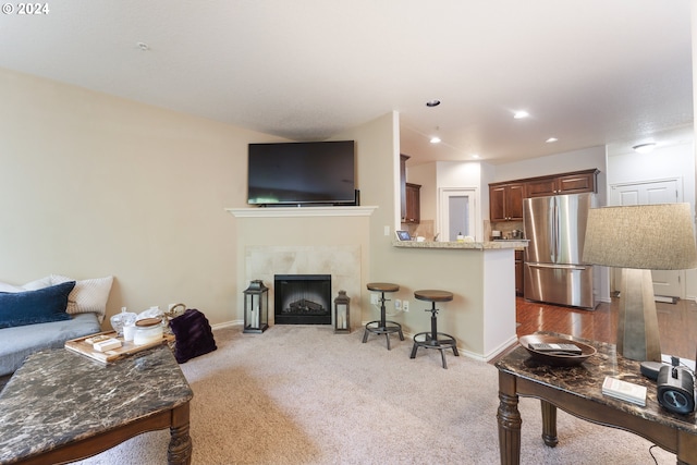 carpeted living room with a fireplace