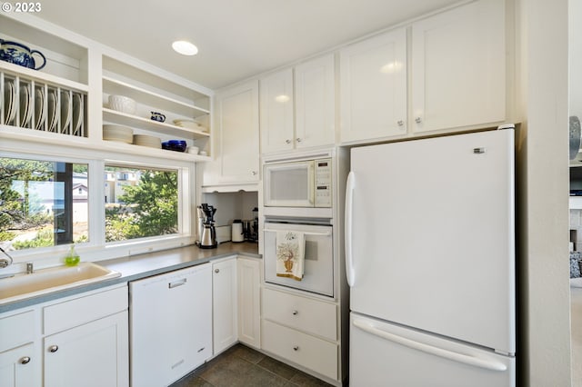 kitchen featuring white cabinets, white appliances, and sink